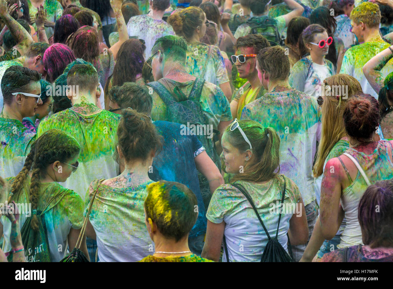 Many young women and man are colored by colorpowder at the colorful Holi festival, Dresden, Saxony, Germany Stock Photo