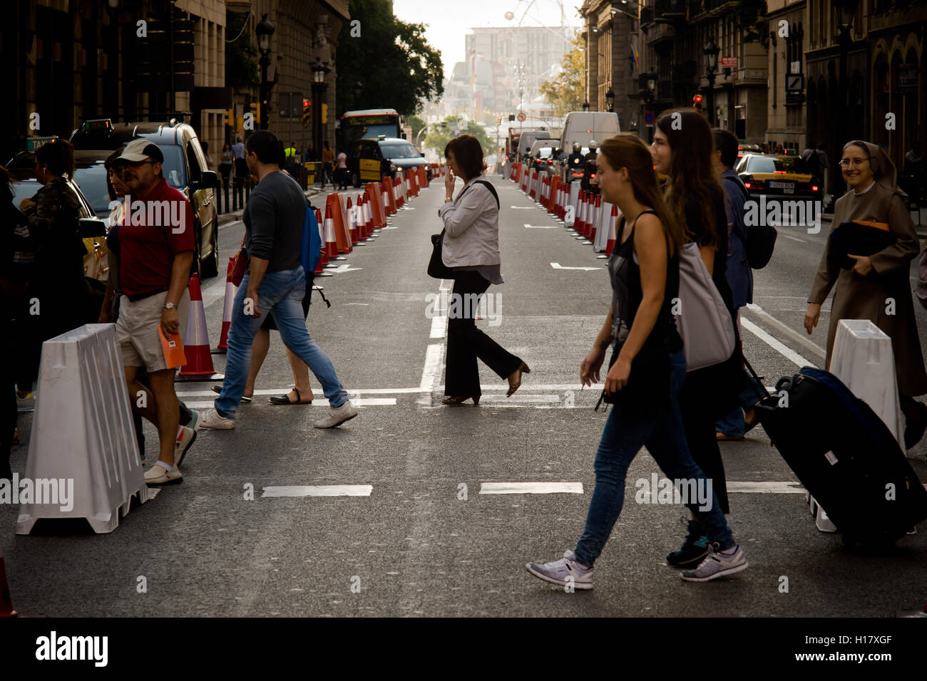 Pedestrians walk by Via Laietana street in Barcelona downtown . Stock Photo
