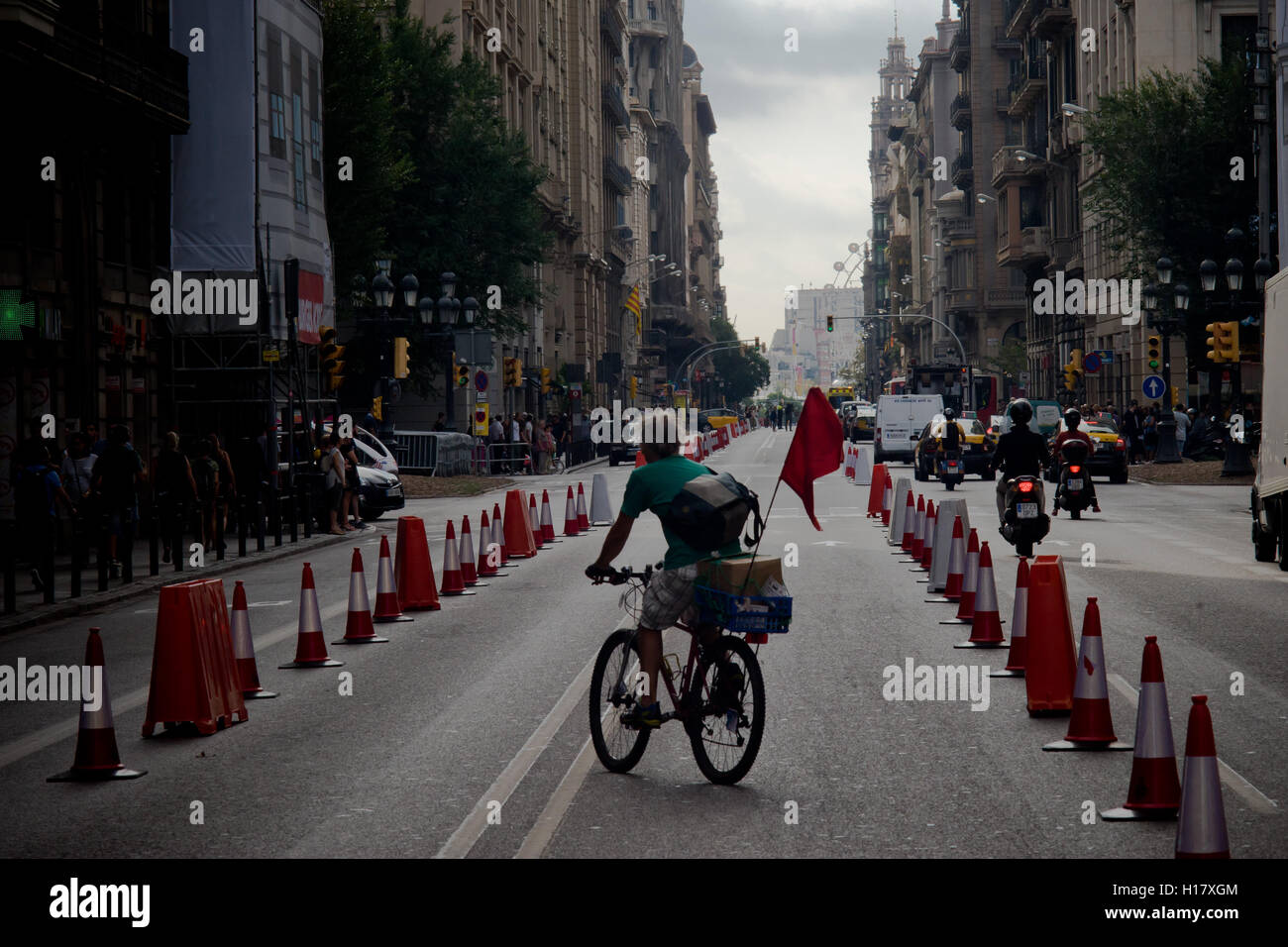 A man  rides his bicycle by Via Laietana street in Barcelona downtown. Stock Photo