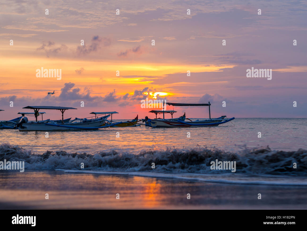 sunrise over fishing boats in Kuta Bali Stock Photo