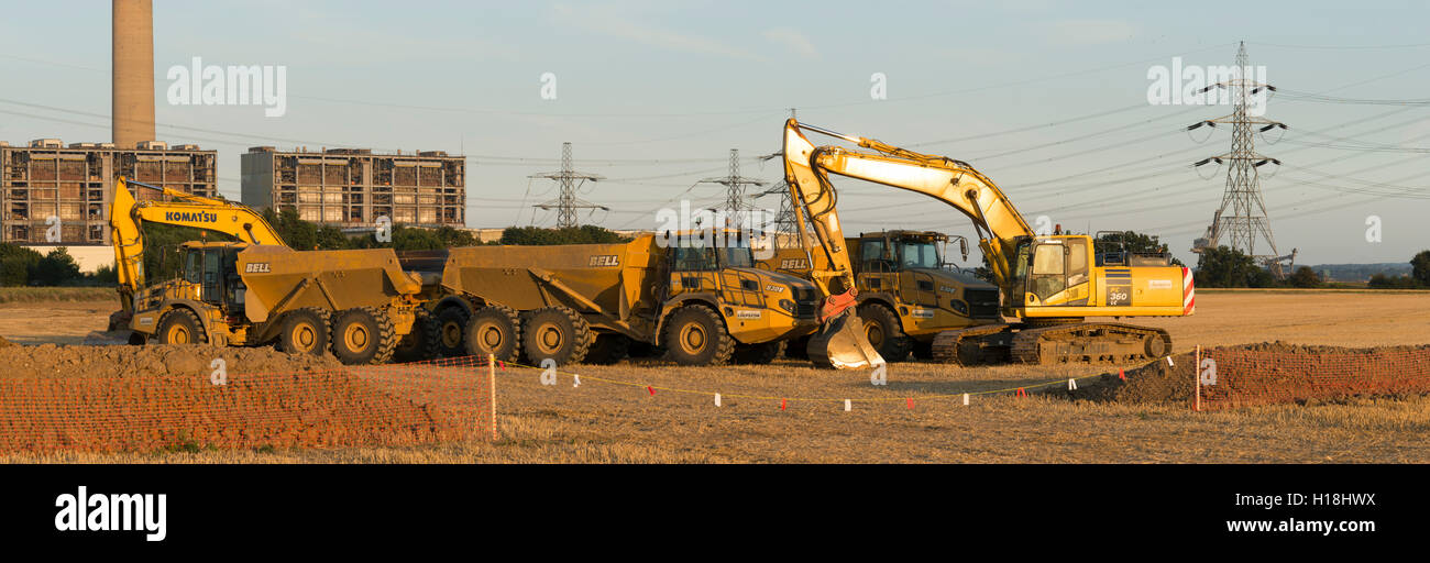 Kingsnorth quarry, hoo. Excavators & dump trucks all parked up on the field which will become phase 2. The power station featuring in the background Stock Photo