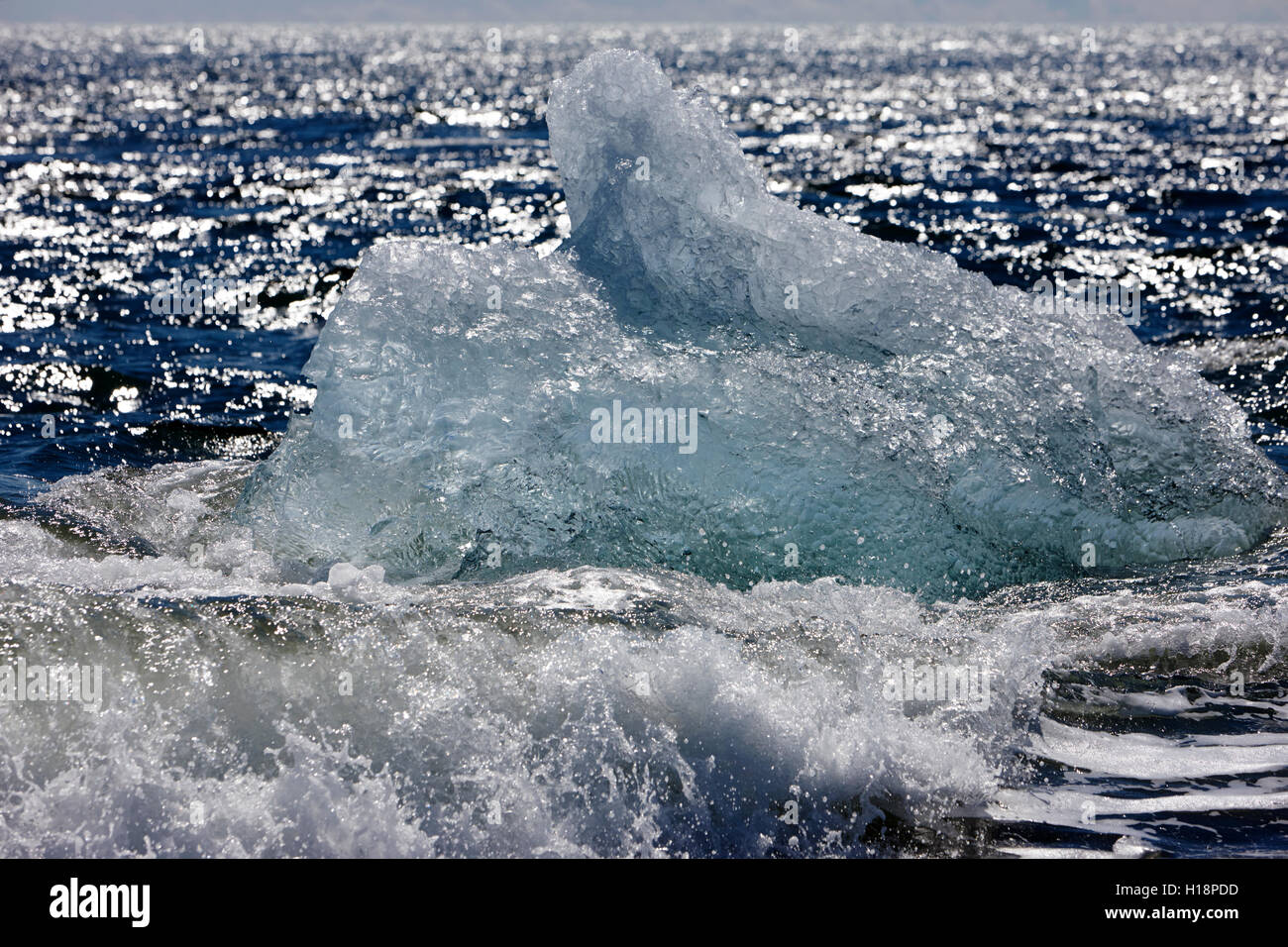 Iceberg washing up on black sand beach at jokulsarlon iceland Stock Photo
