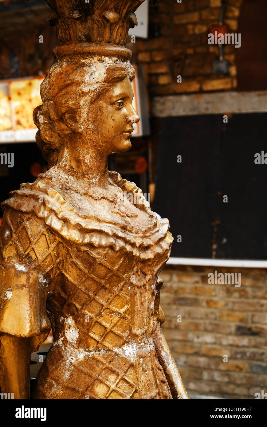 golden column shaped like a lady, Camden Market, London, UK Stock Photo