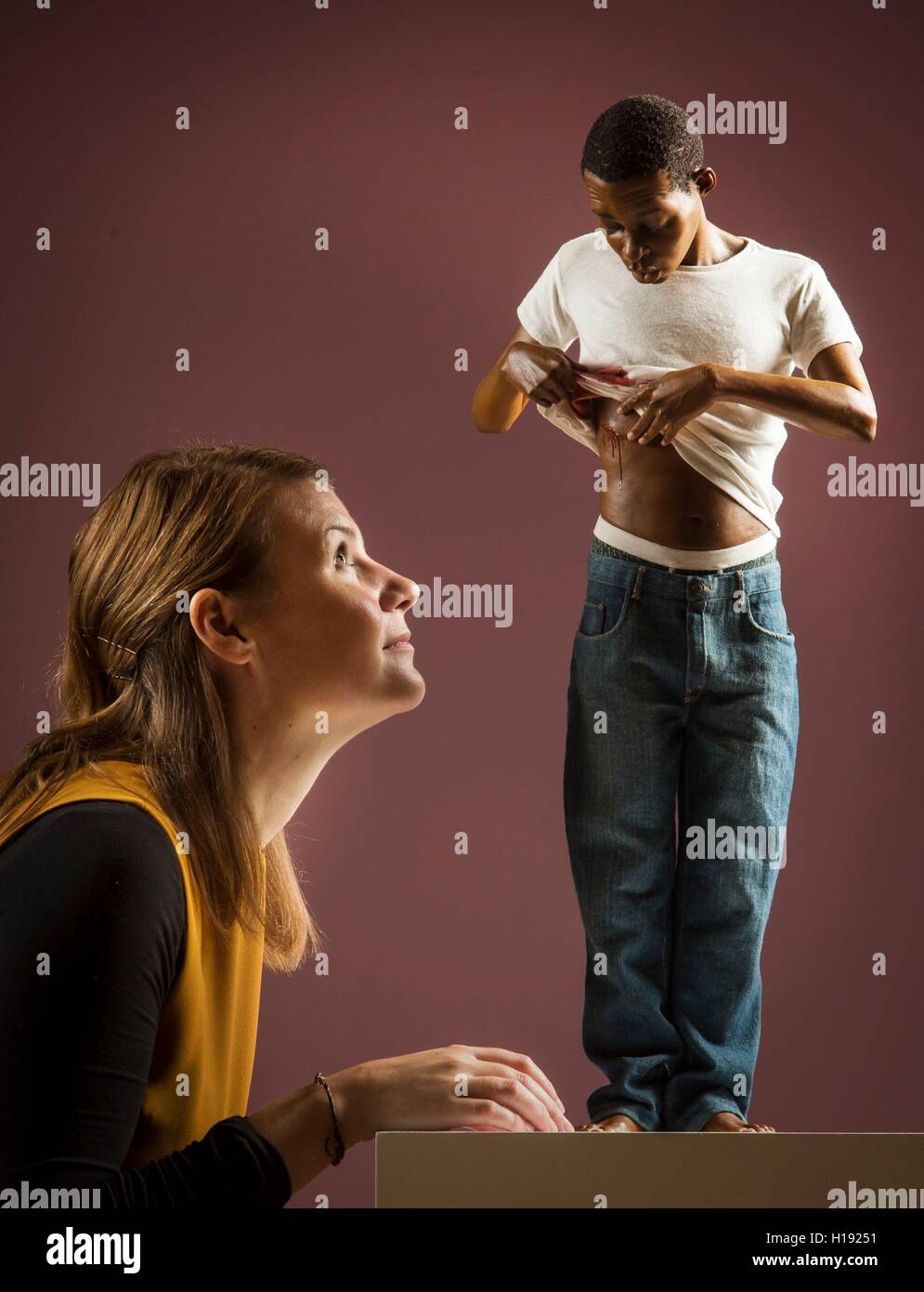 Lauren Masterman looking at Youth (2009) by Ron Mueck, which features in a new exhibition, Flesh, at York Art Gallery. Stock Photo