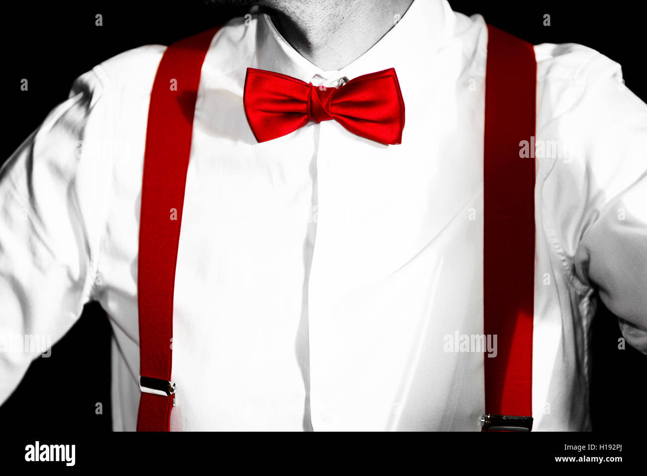 Conceptual costume. Red bow-tie and braces. Jazzbow on white shirt  background. Elegance and chic Stock Photo - Alamy