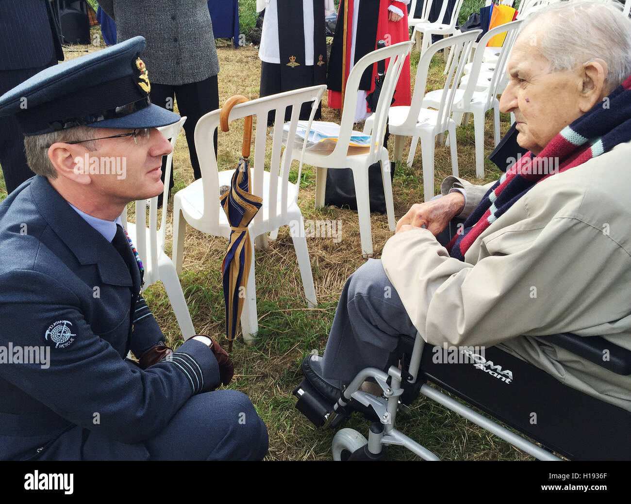 Wing Commander Mike Ainsworth, of RAF Wittering speaks to Maxey Stacey, 86, who witnessed the Spitfire crash in which pilot Harold Penketh died in 1940, during an unveiling of a permanent memorial near the site where his plane was excavated at Holme Lode, the Great Fen, Cambridgeshire. Stock Photo