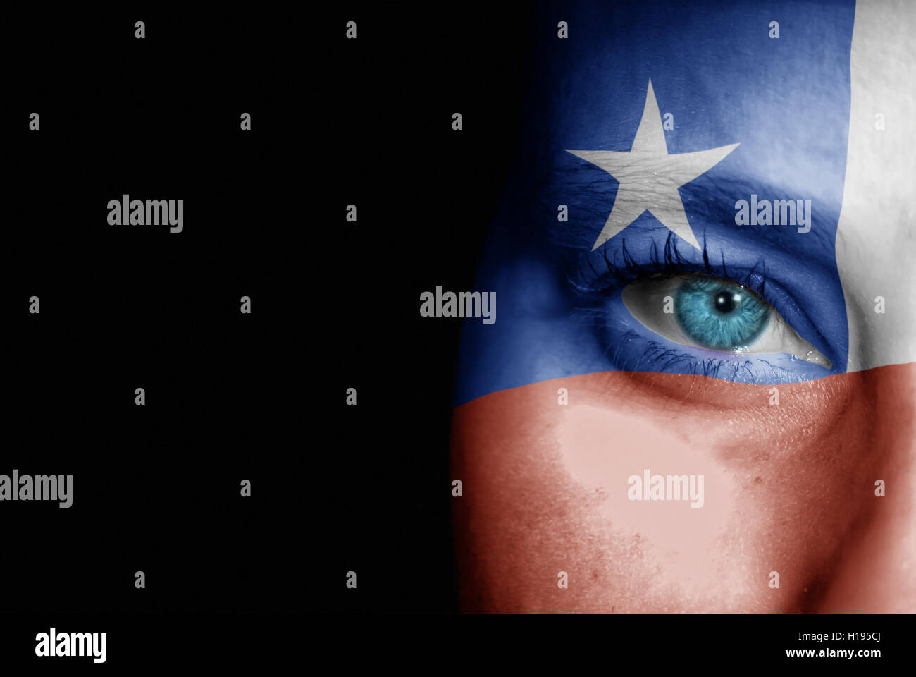 A young female with the flag of Chile painted on her face on her way to a sporting event to show her support. Stock Photo