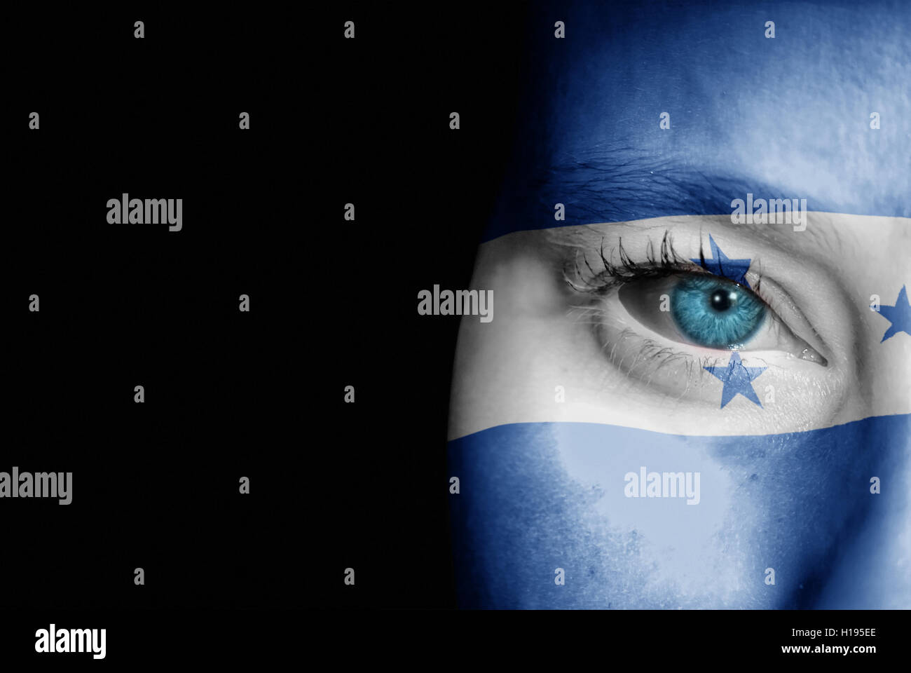 A young female with the flag of Honduras painted on her face on her way to a sporting event to show her support. Stock Photo