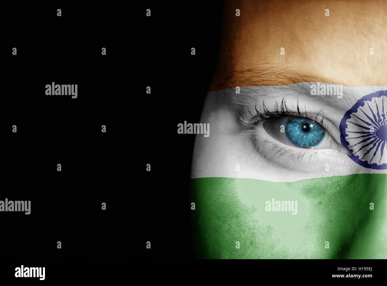 A young female with the flag of India painted on her face on her way to a sporting event to show her support. Stock Photo