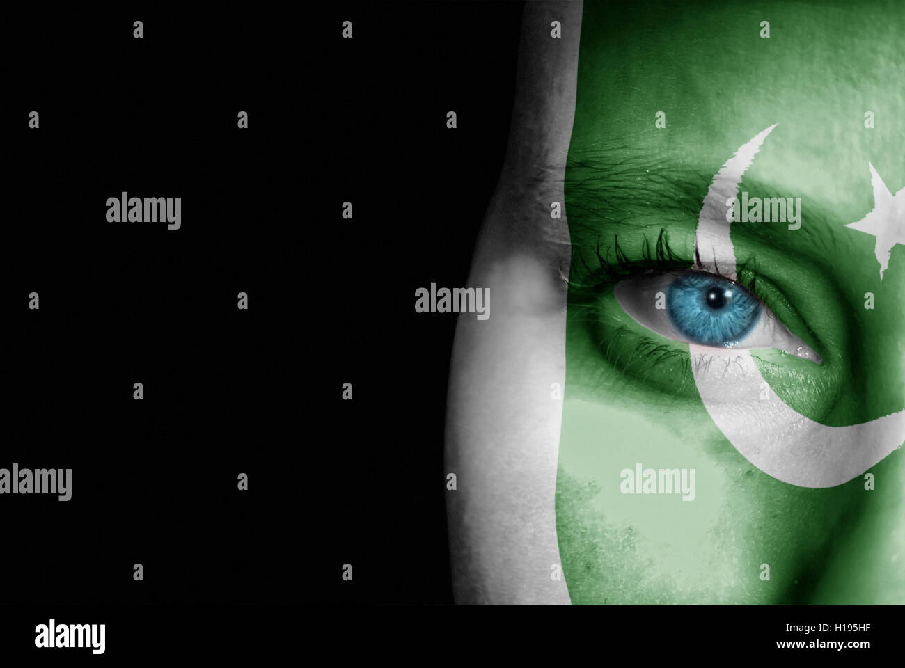 A young female with the flag of Pakistan painted on her face on her way to a sporting event to show her support. Stock Photo