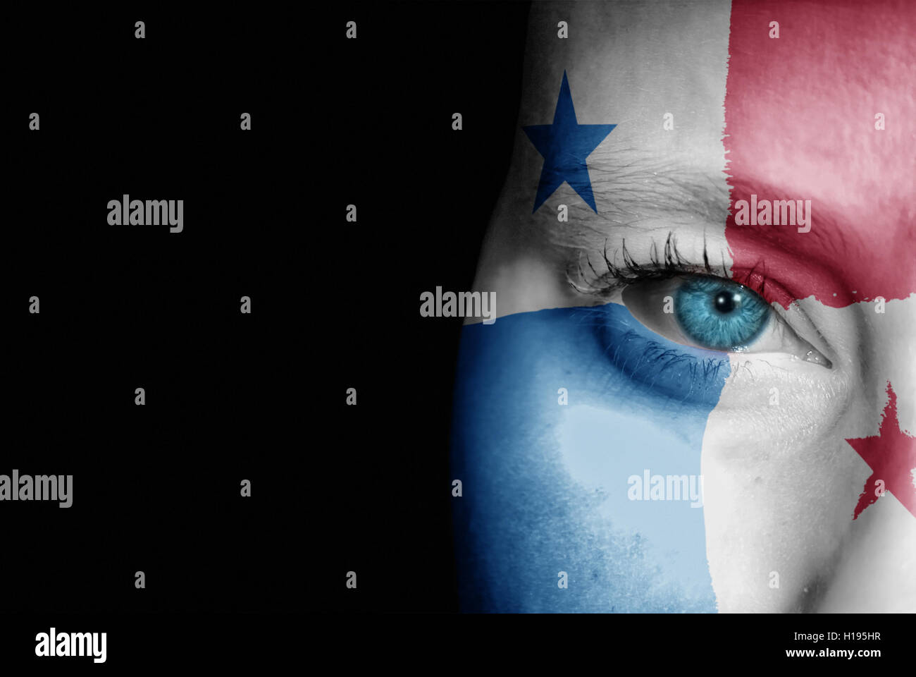 A young female with the flag of Panama painted on her face on her way to a sporting event to show her support. Stock Photo