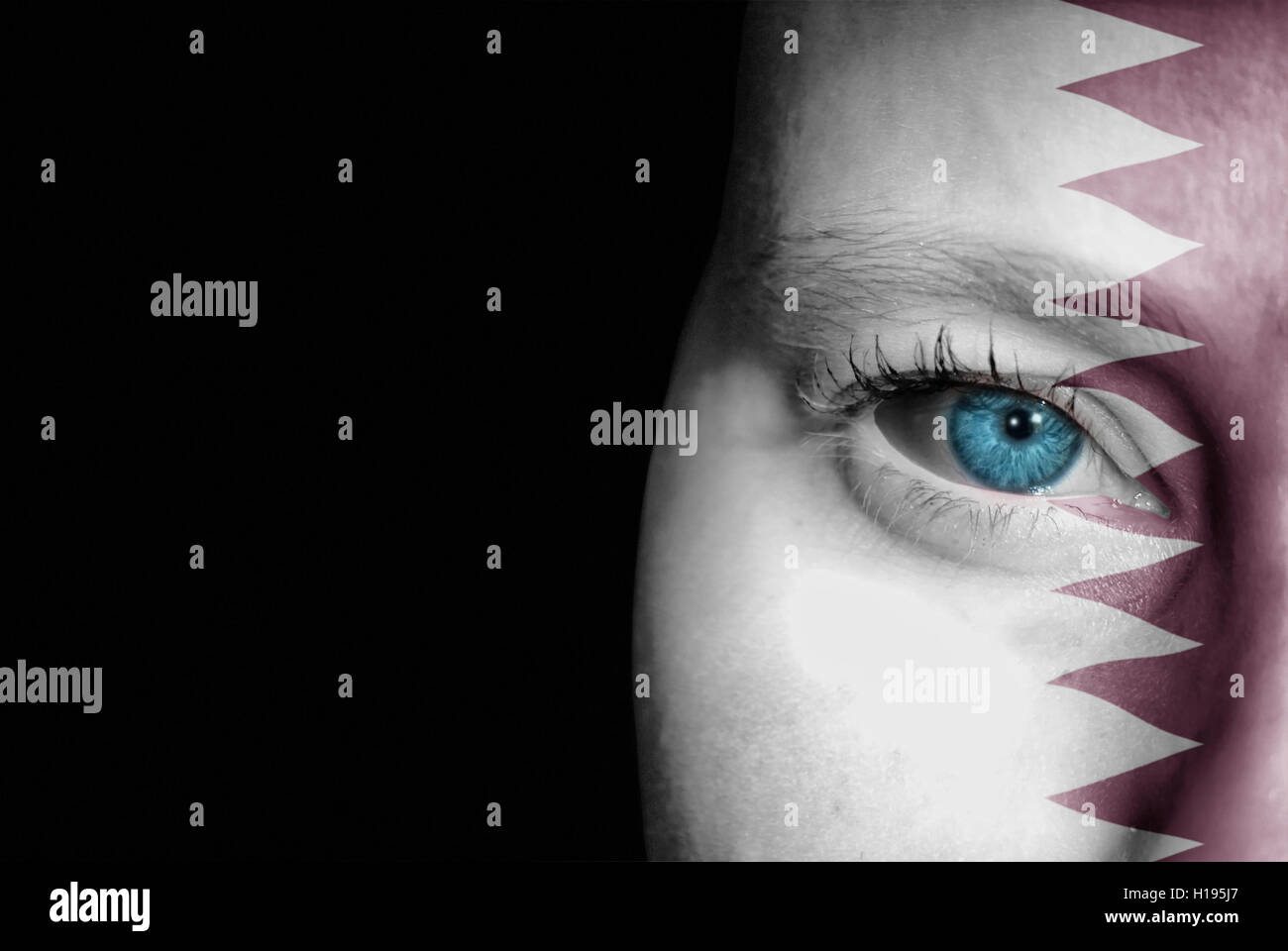 A young female with the flag of Qatar painted on her face on her way to
