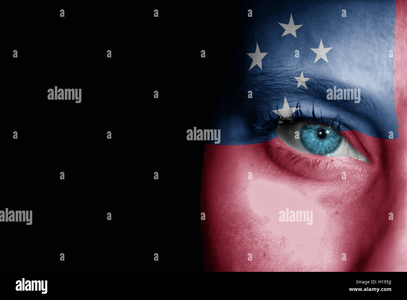 A young female with the flag of Samoa painted on her face on her way to a sporting event to show her support. Stock Photo