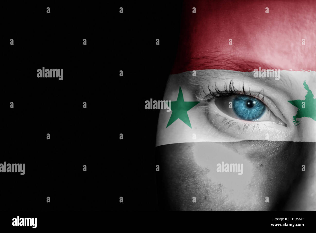 A young female with the flag of Syria painted on her face on her way to a sporting event to show her support. Stock Photo