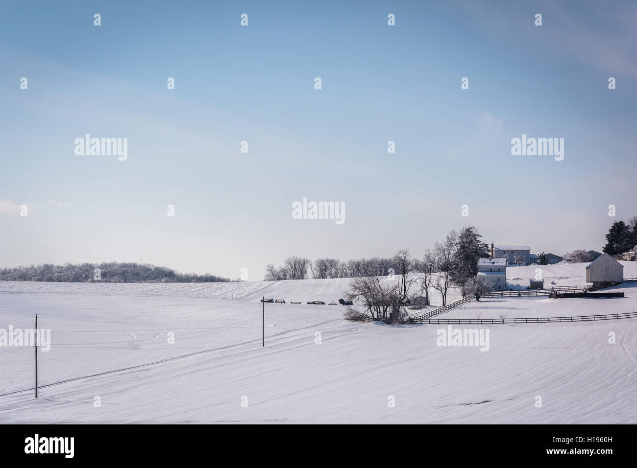 Winter view of snow covered farm fields in rural Carroll County, Maryland. Stock Photo