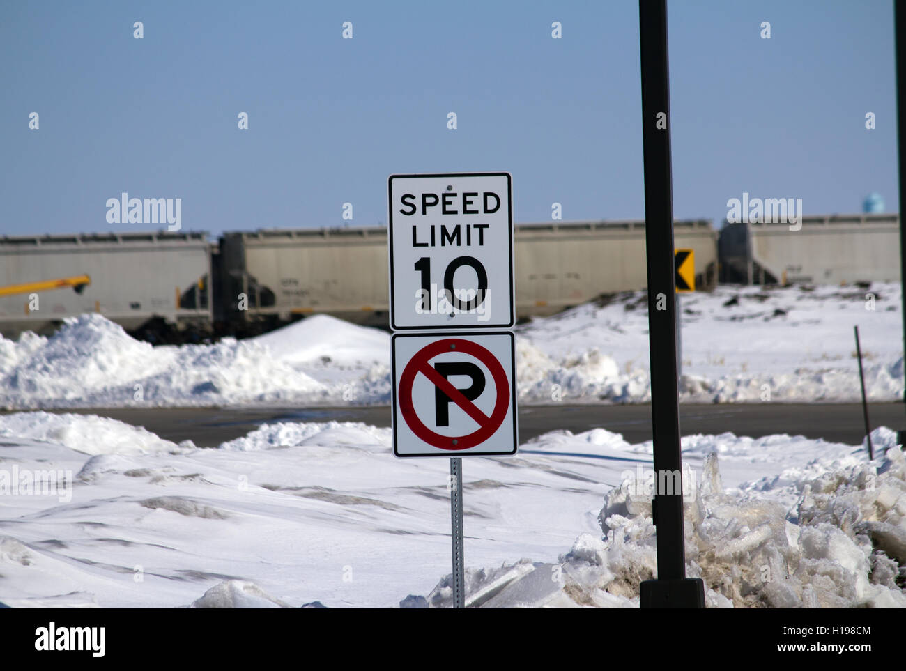 Speed Limit No Parking Sign Next to Train Stock Photo