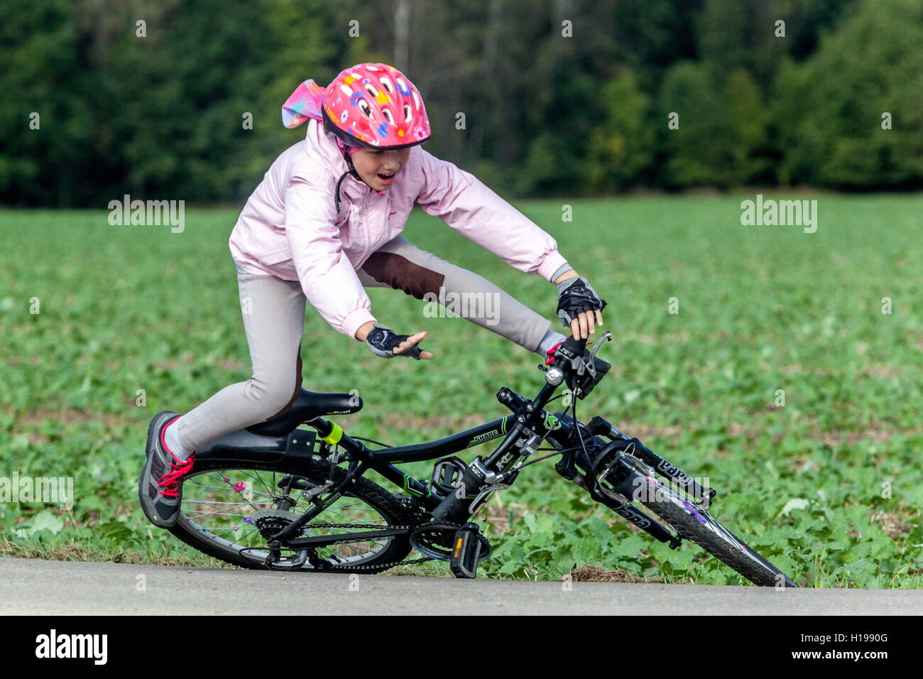 Child fall bike accident ride helmet, fall off bike Stock Photo