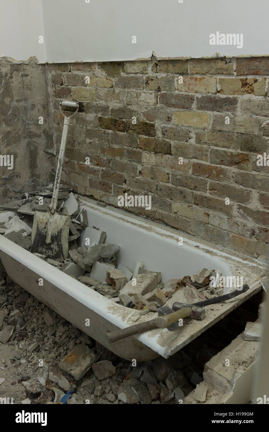bathroom renovation after tiles have been removed from wall Stock Photo