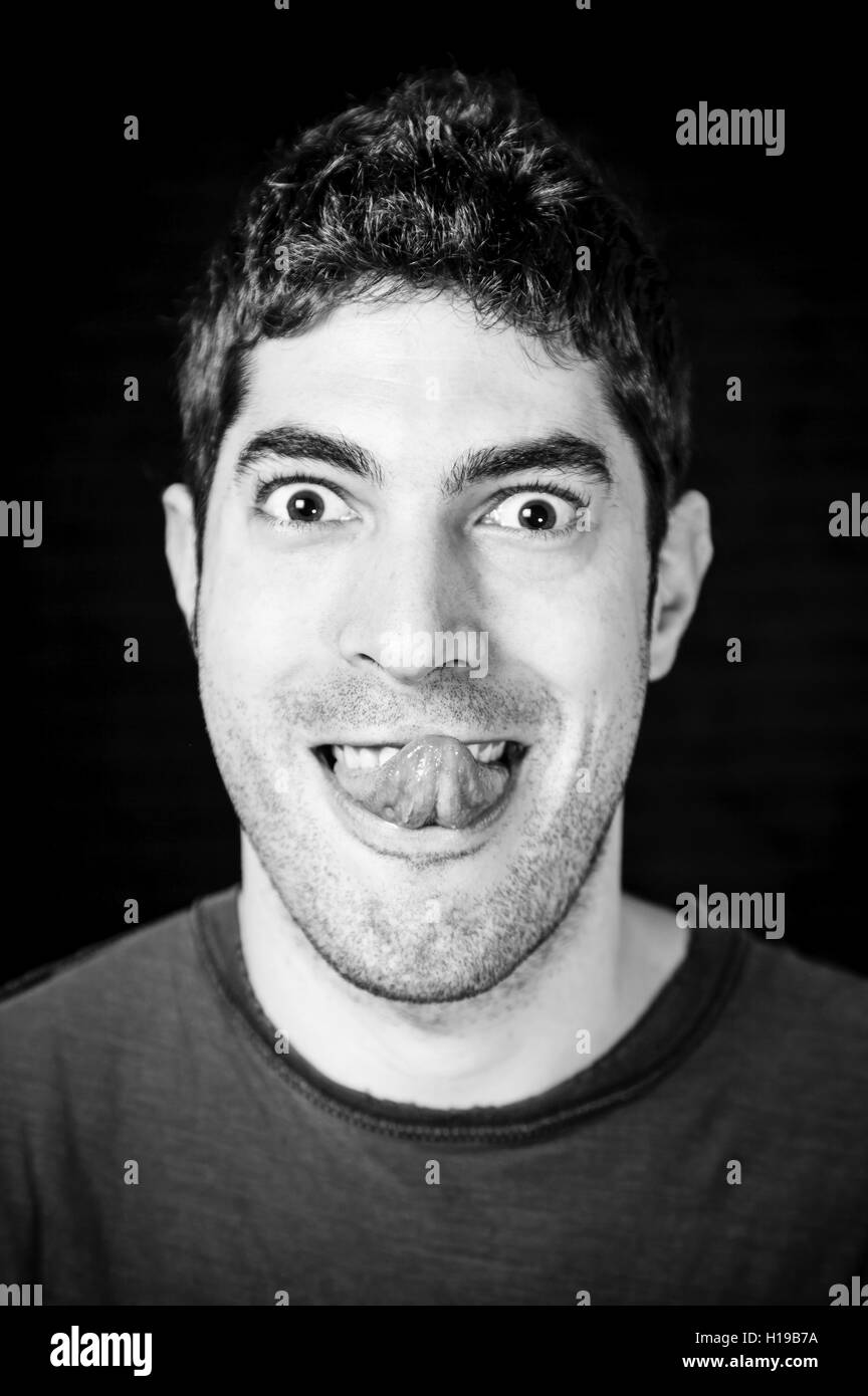 Boy silly face sticking out his tongue, expression Stock Photo