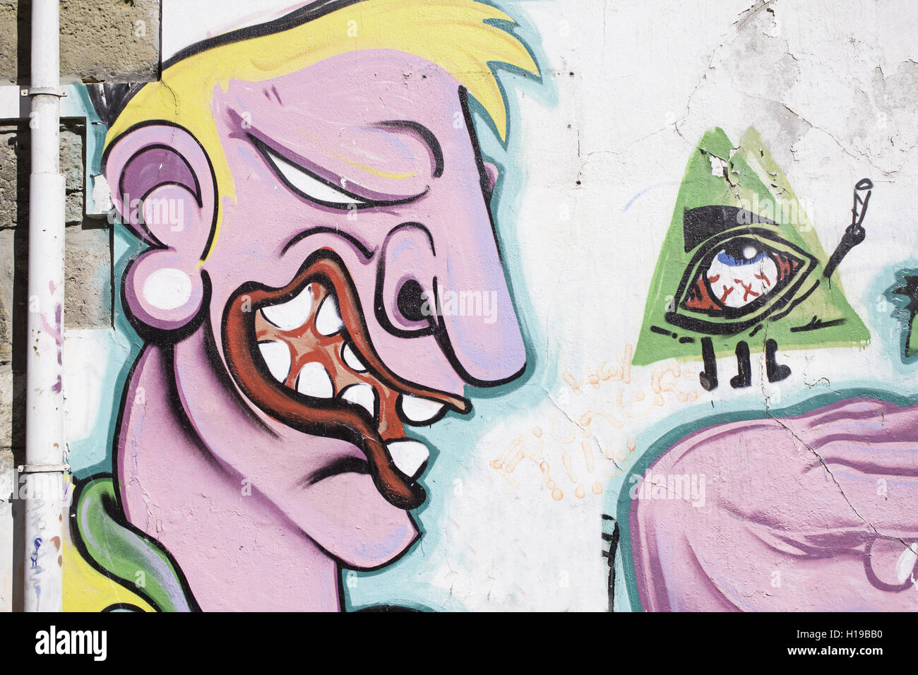 Strange man with eye wall, graffiti Stock Photo