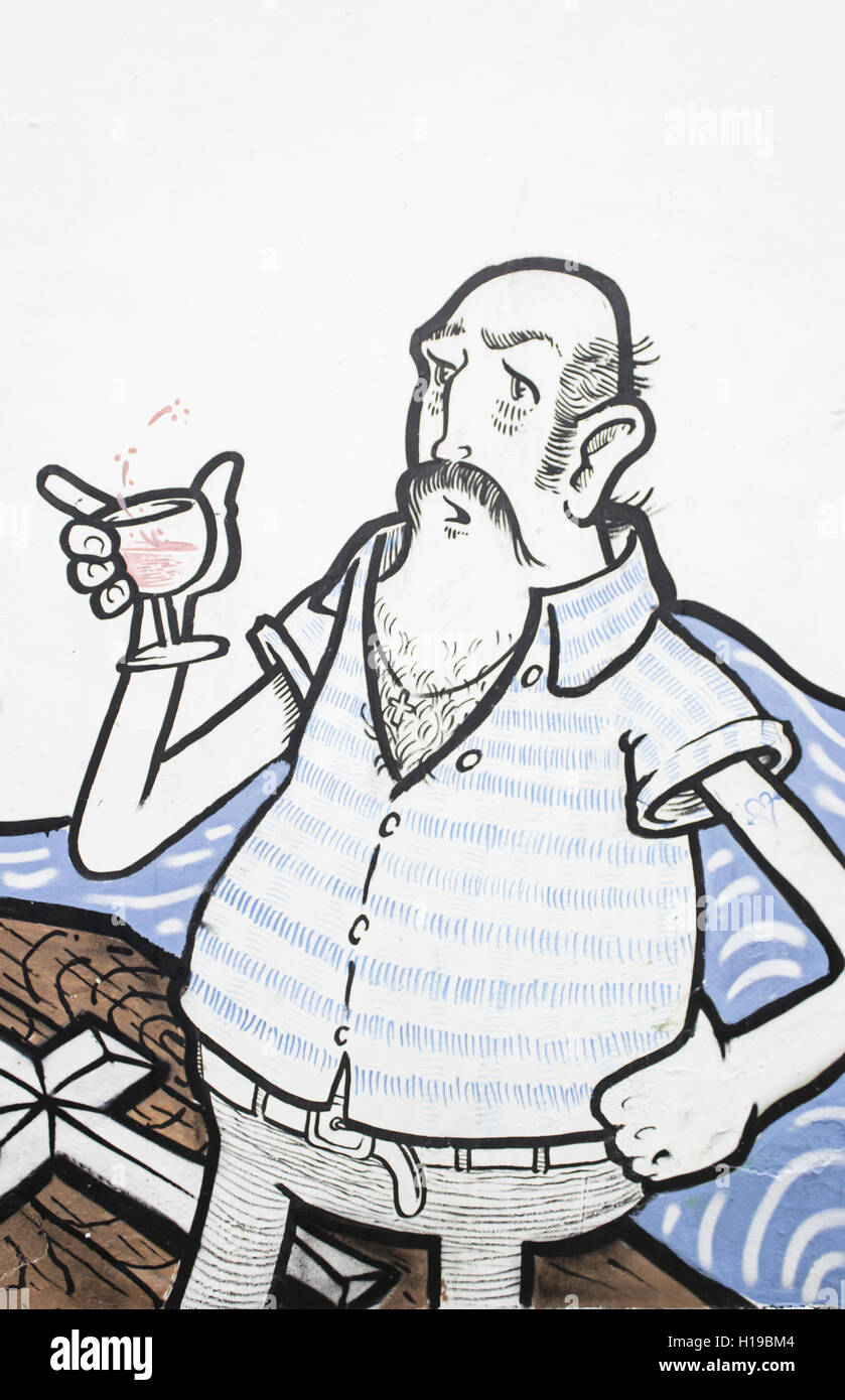 Man drinking wine drawn on the wall, graffiti Stock Photo