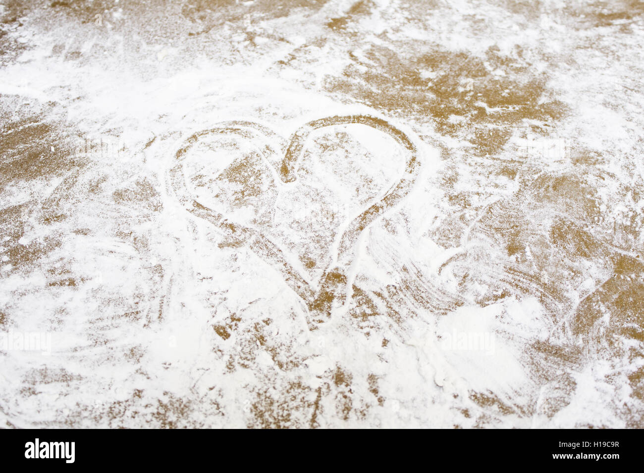 Heart drawn in flour, and love symbol Stock Photo Alamy