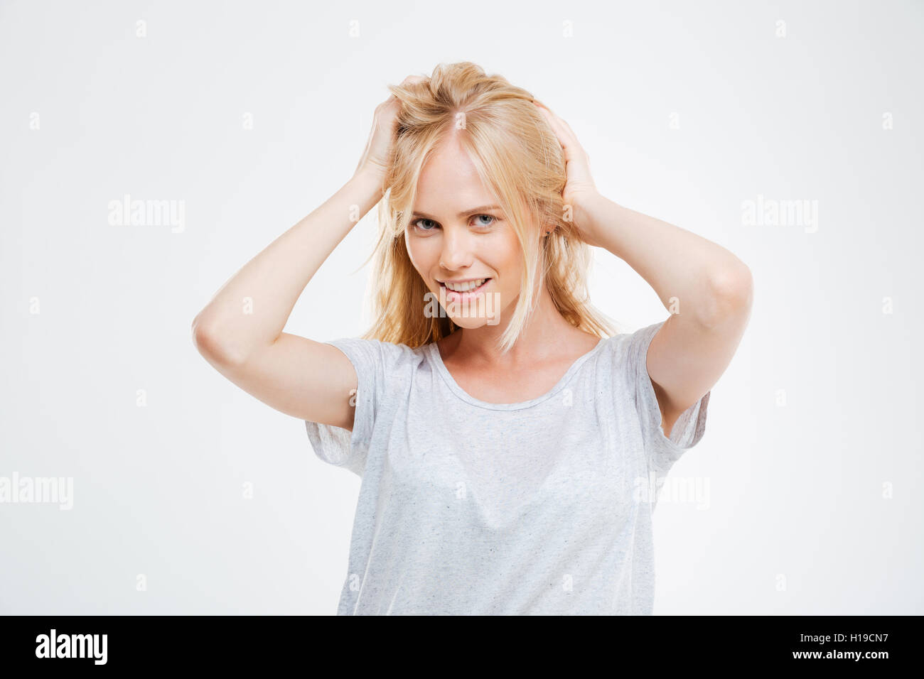 Portrait of happy beautiful young woman with blonde hair over white background Stock Photo