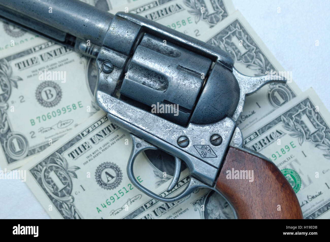 Gun on Dollars Stock Photo Alamy