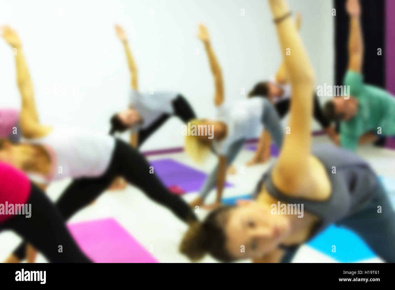 Group of People Practicing Yoga at Health Club Blurred. Yoga, Sport, Fitness, Lifestyle and People Concept. Stock Photo
