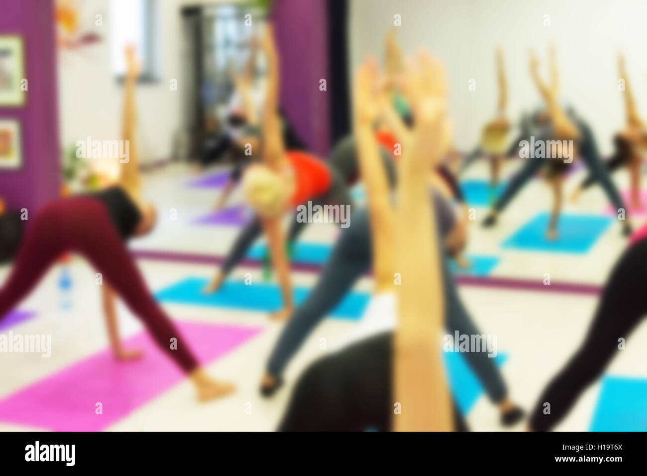 Group of People Practicing Yoga at Health Club Blurred. Yoga, Sport, Fitness, Lifestyle and People Concept. Stock Photo