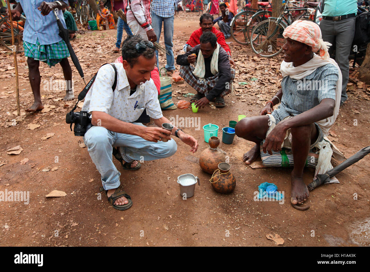 Vendor selling Madi (Natural Liquor) Dhurwa Tribal Market, Pandripani Village, Chattisgadh, India Stock Photo