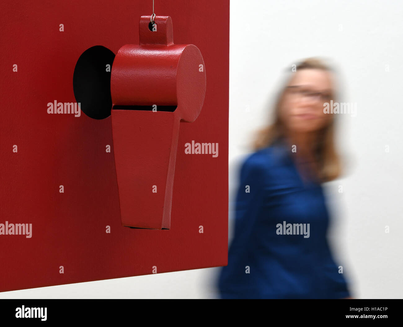 A woman walks past the artwork 'Mehr als eine Sprechblase' (2001) by Bogomir Ecker at an exhibition preview at the Arts Collections in Chemnitz, Germany, 22 September 2016. From 25 September 2016 the Arts Collections Chemnitz will show 100 artworks from renowned national and international members of the Academy of the Arts in Berlin. It is the first time that all 67 members of the section visual arts exhibit together. The works from the fields of painting, photography, sculpture, film, video and concept arts are on display until 20 November 2016. PHOTO: HENDRIK SCHMIDT/dpa Stock Photo