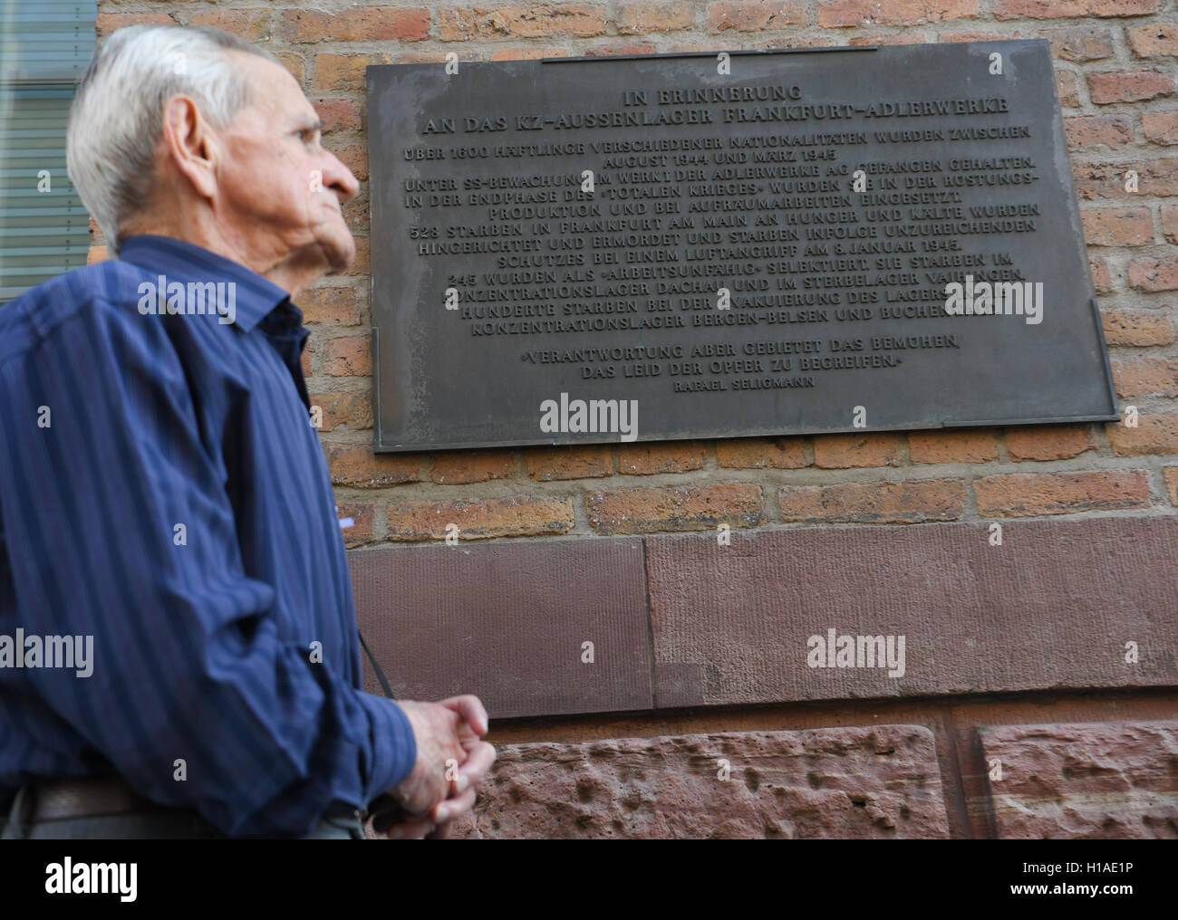 The 86-year-old concentration camp survivor Andrzej Branecki from Poland stands by a memorial plaque for the concentration camp satellite camp Frankfurt Adler factory during a visit to the former Adler factory in Frankfurt am Main, Germany, 06 September 2016. He was brought to the Adler factory in Frankfurt am Main for forced labor in January 1945. Photo: ARNE DEDERT/dpa Stock Photo