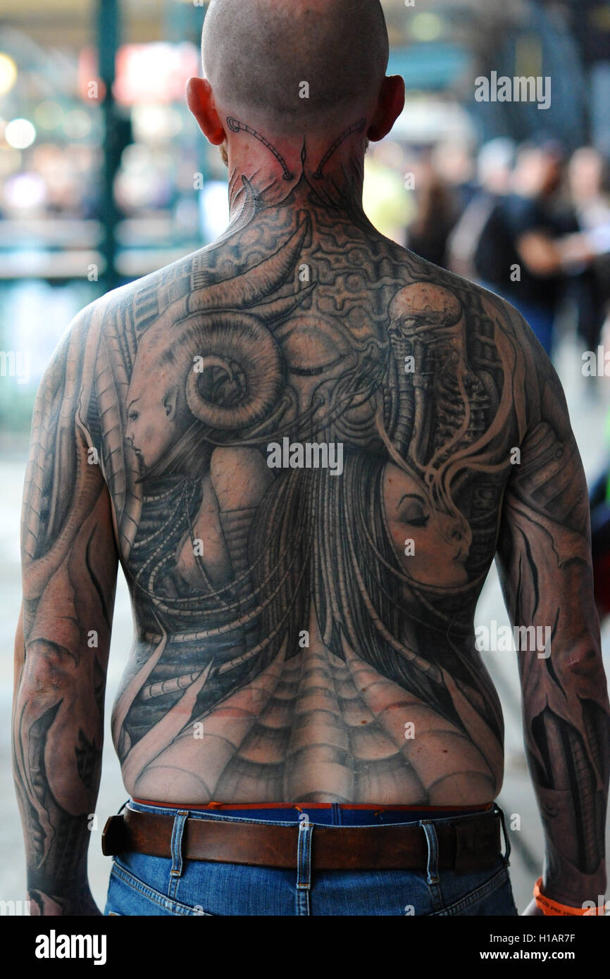 London, UK. 23rd Sep, 2016. A man with a full back body tattoo at the 12th London International Tattoo Convention, which opened today in Tobacco Dock, east London.  The show features over 400 of the world’s finest, most prestigious and elite tattoo artists as well as a showcasing alternative culture in the form of piercing, burlesque and the Miss Pin Up UK competition. Around 20,000 people will attend over the weekend. Credit:  Michael Preston/Alamy Live News Stock Photo
