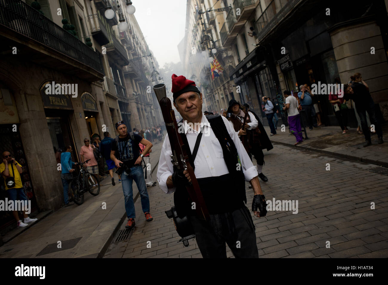 Barcelona, Catalonia, Spain. 24th Sep, 2016. A trabucaire through the streets of Barcelona early in the morning on the occasion of the celebrations of the Merce Festival (Festes de la Merce). The Galejada Trabucaire marks the beginning of the day of the patron saint of Barcelona, La Merce. Men and women dressed as ancient Catalan bandits take to the streets of the old part of Barcelona and cause a loud noise with his blunderbusses full of gunpowder. © Jordi Boixareu/ZUMA Wire/Alamy Live News Stock Photo
