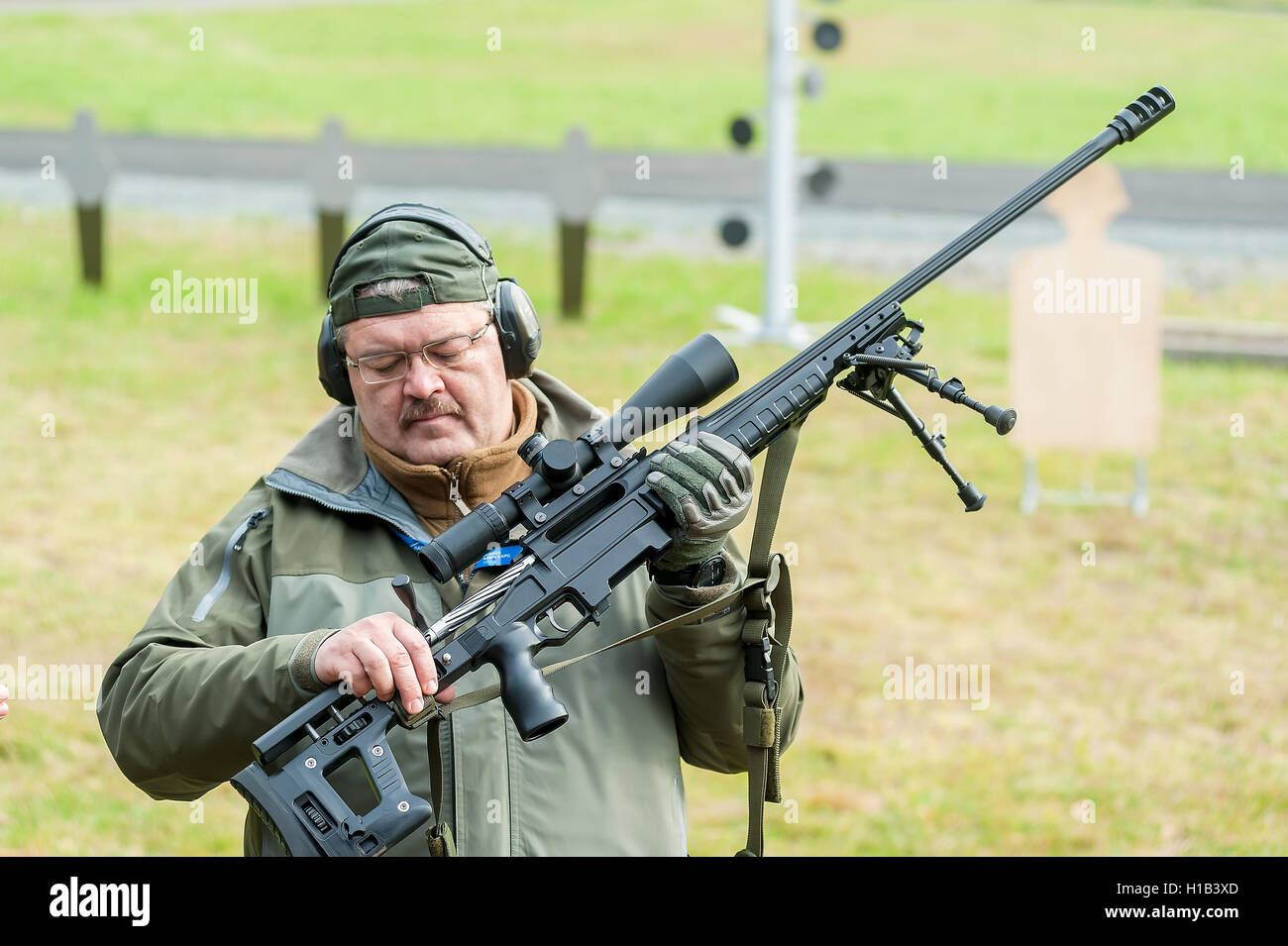 Representative of firm shows rifle ORSIS T-5000 Stock Photo