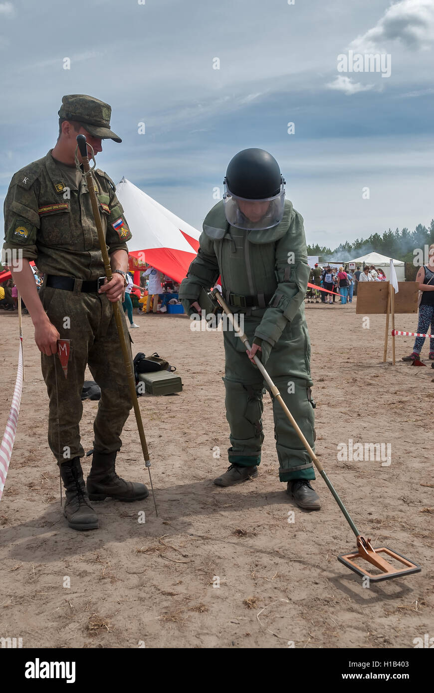Man - visitor of show tries on the sapper suit Stock Photo