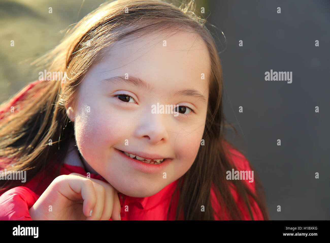 Portrait of little girl smiling outside Stock Photo - Alamy