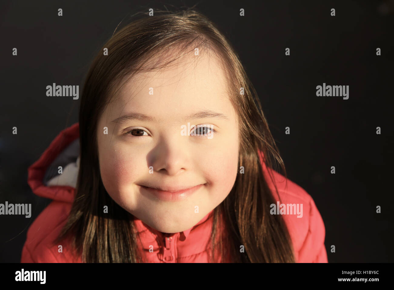 Portrait of little girl smiling outside Stock Photo - Alamy
