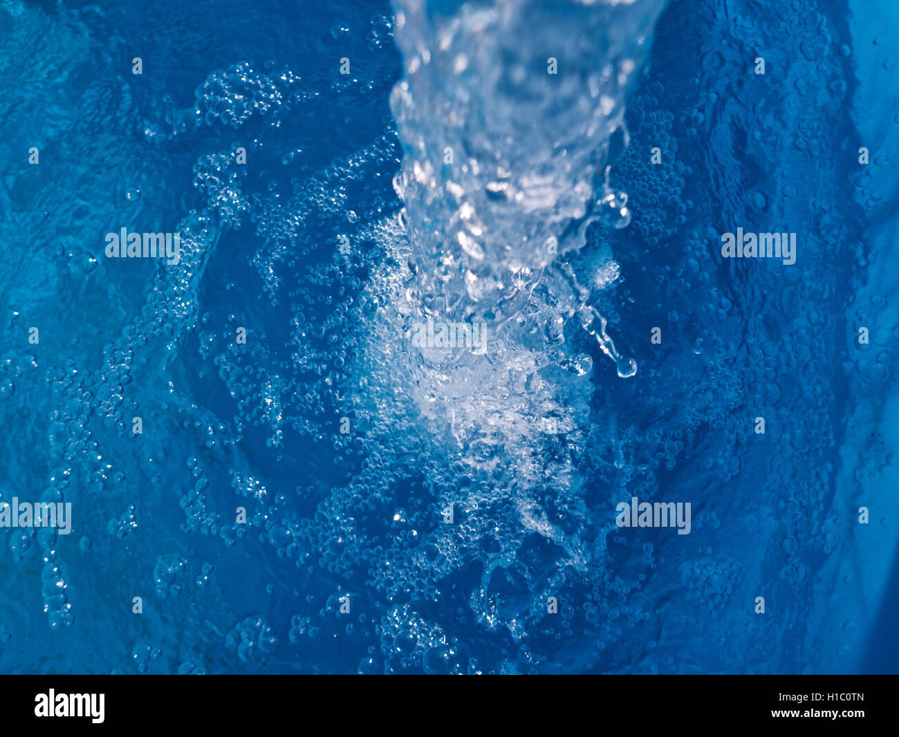 Water flowing, oxygenating air bubbles. Stock Photo
