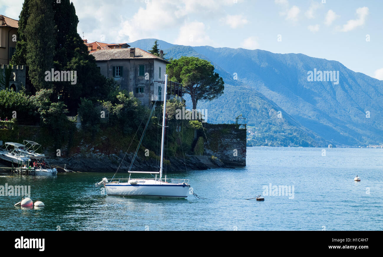 Varenna, Italy - September 4th, 2015: tourists embark on a boat in Varenna (Lake Como, Italy), with another white boat in the fo Stock Photo