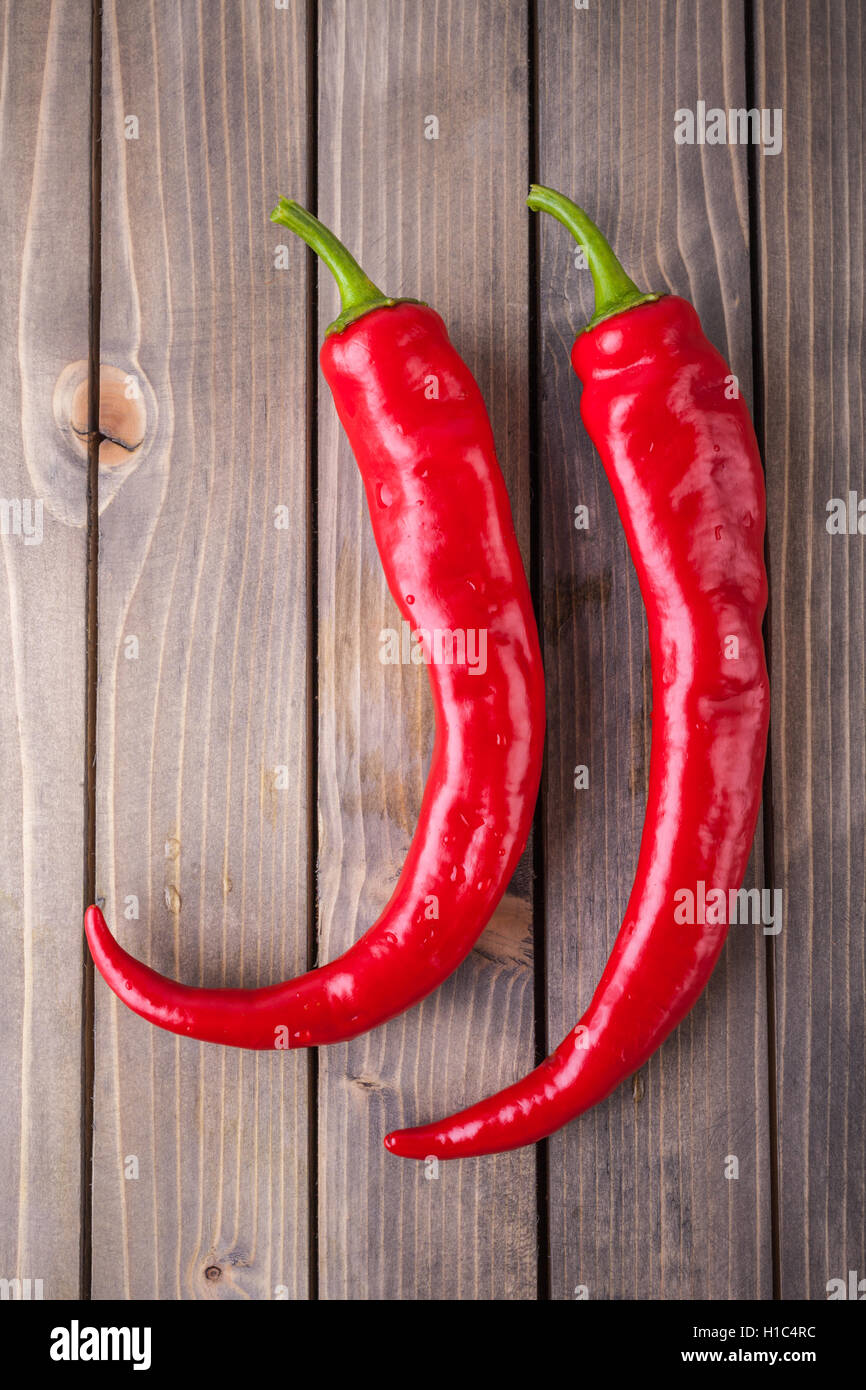 Red hot chili peppers on wood background Stock Photo - Alamy