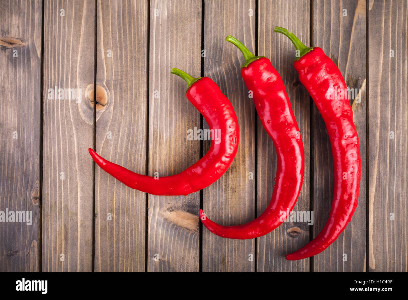 Red hot chili peppers on wood background Stock Photo - Alamy