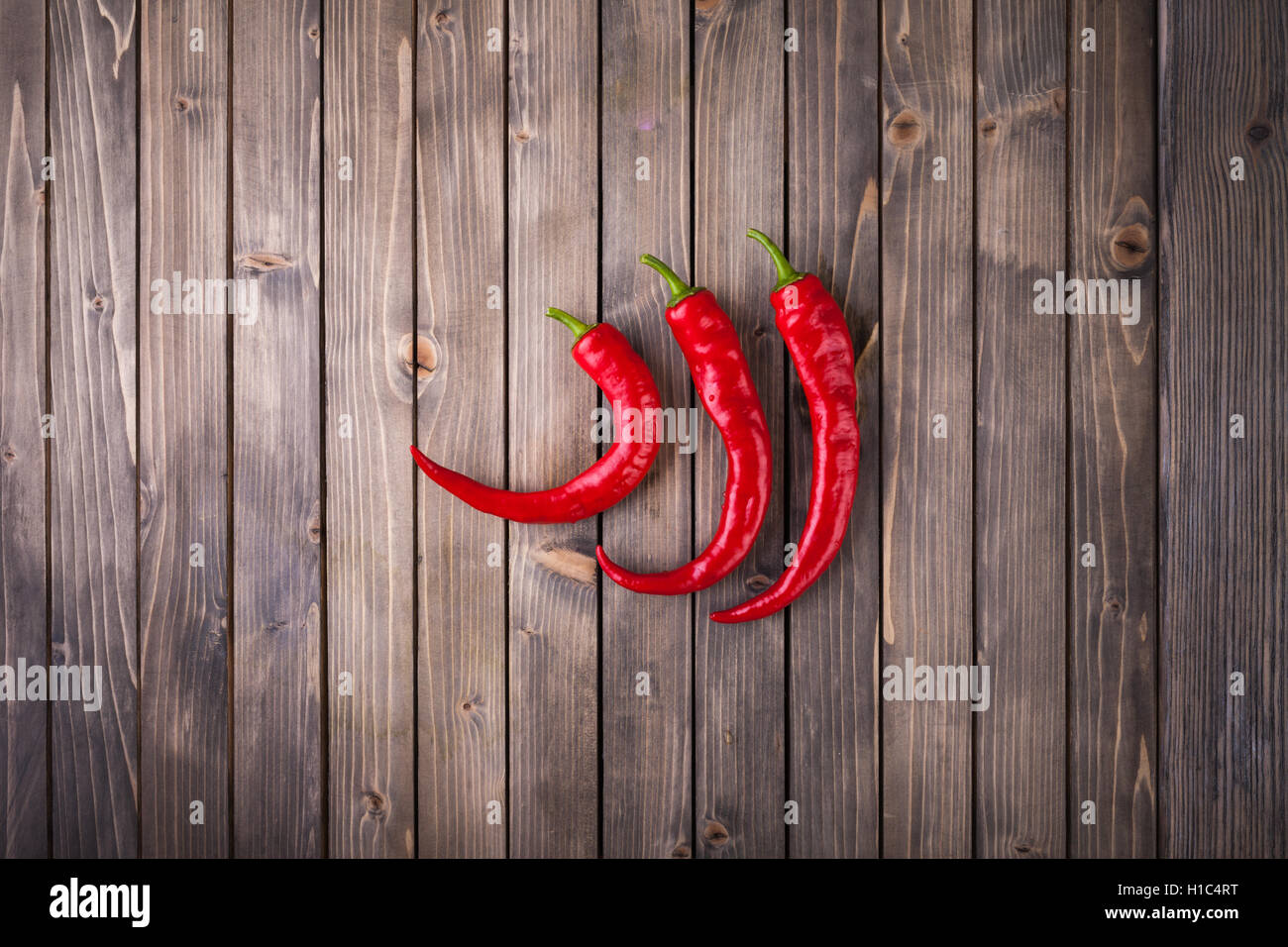 Red hot chili peppers on wood background Stock Photo - Alamy