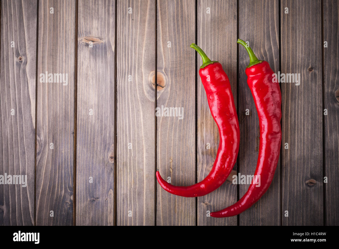 Red hot chili peppers on wood background Stock Photo - Alamy