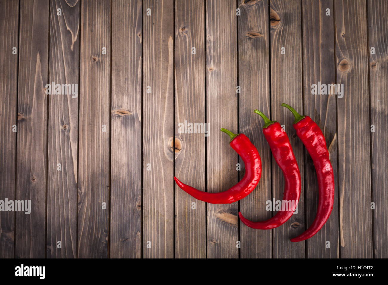 Red hot chili peppers on wood background Stock Photo - Alamy