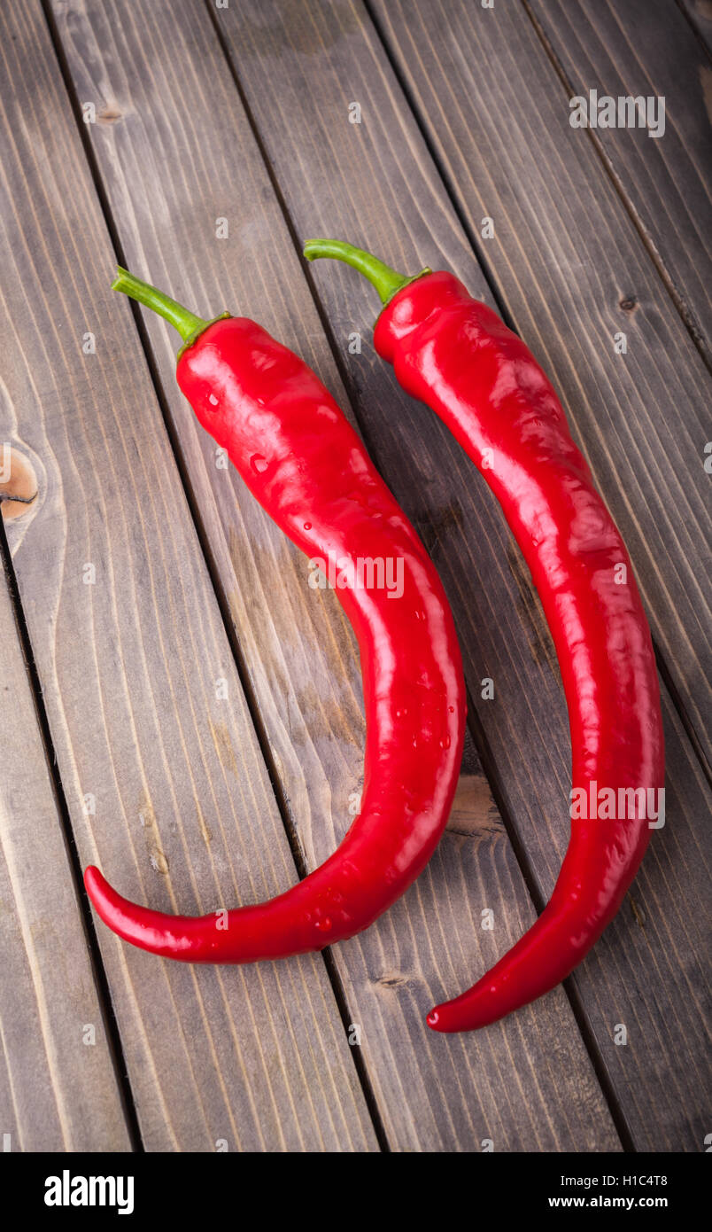 Red hot chili peppers on wood background Stock Photo - Alamy