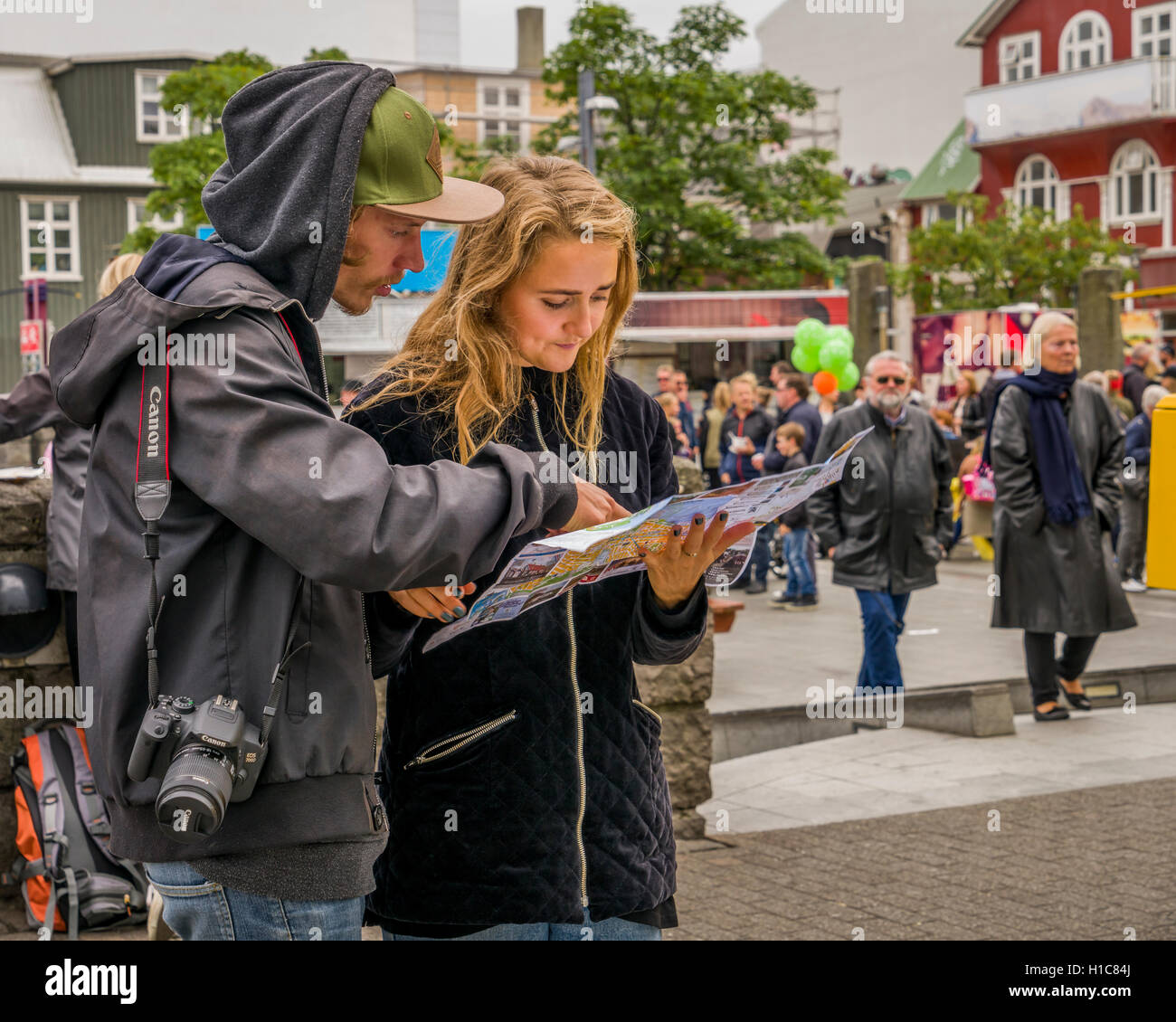 Couple looking at a map during Menningarnott-Cultural Festival in Reykjavik, Iceland Stock Photo