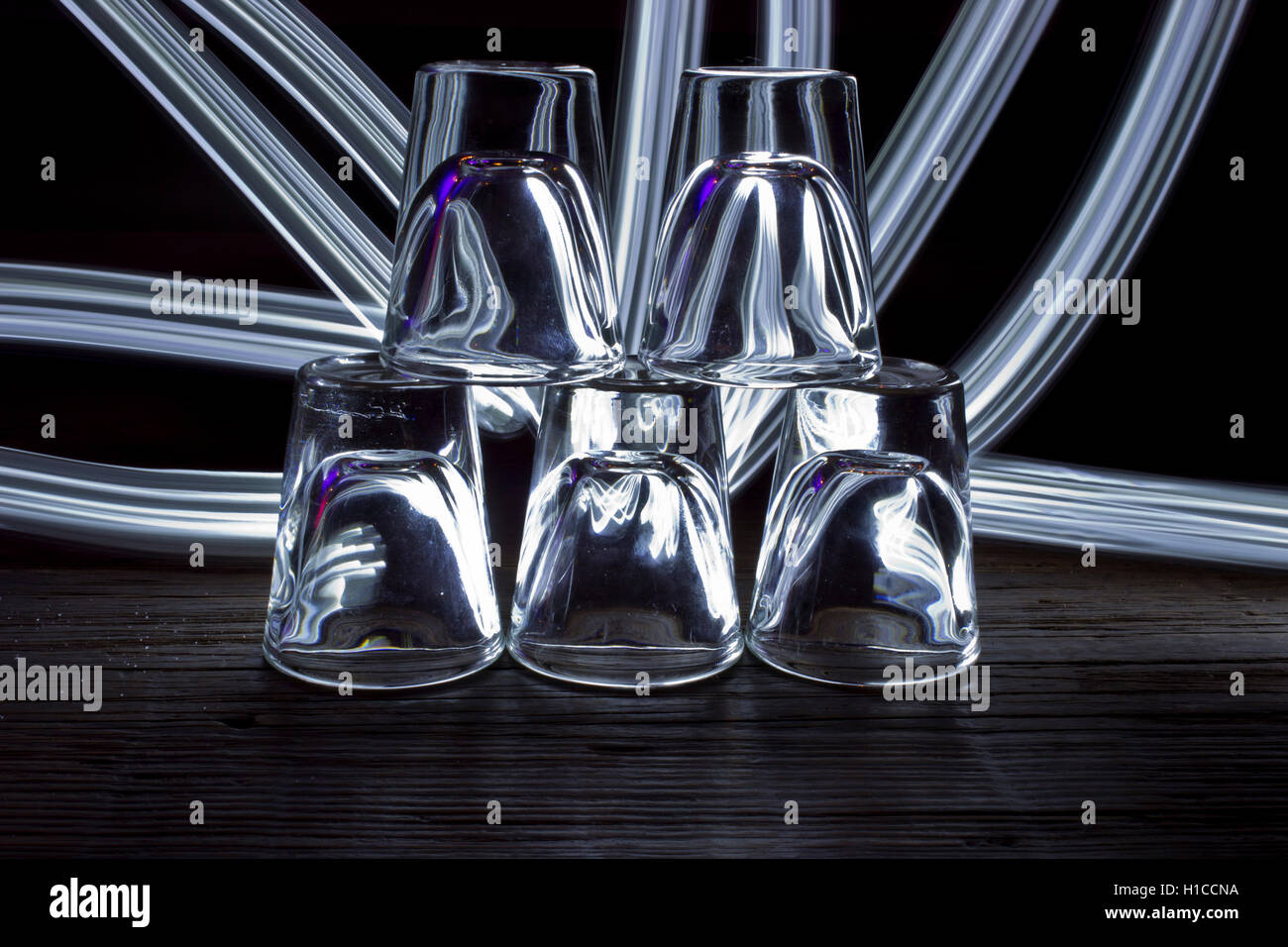 https://c8.alamy.com/comp/H1CCNA/shot-glasses-in-pyramid-with-light-drawing-H1CCNA.jpg