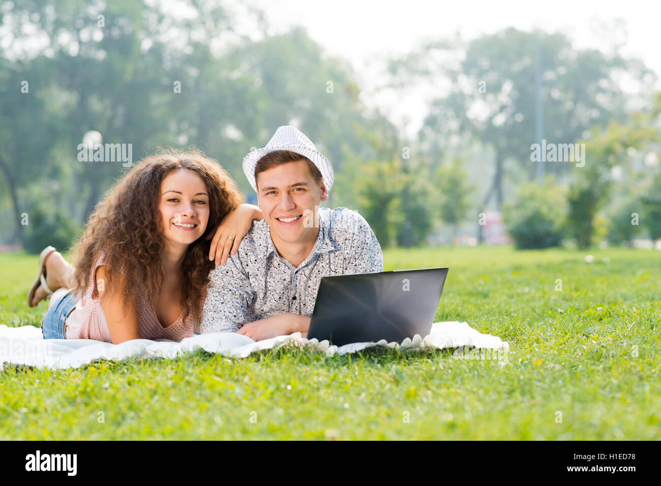 Man Woman Laptop Smiling Lying Happiness Grass Two People High Resolution Stock Photography And Images Alamy